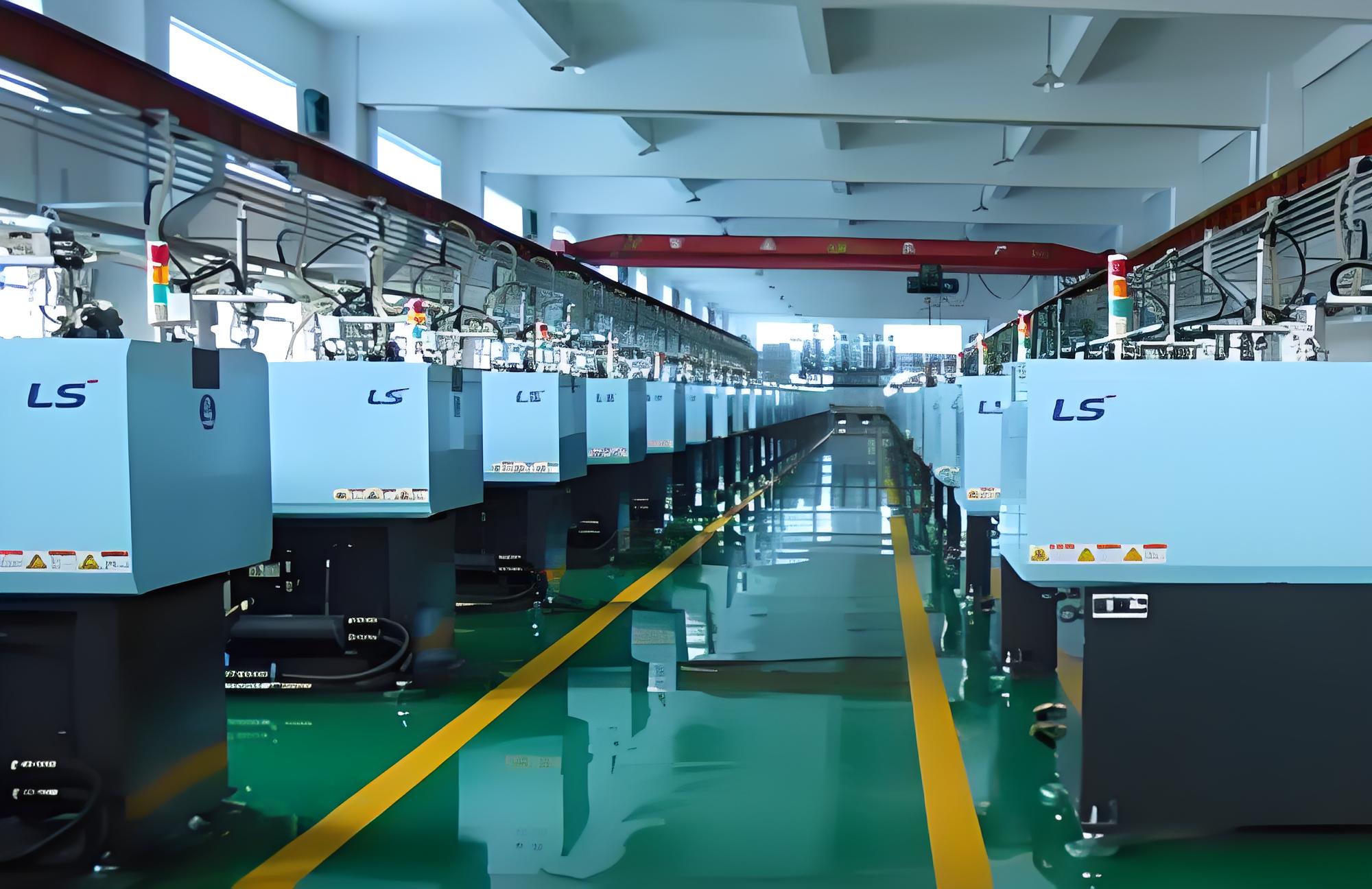 Interior of a plastic mould manufacturing factory with machines and workers