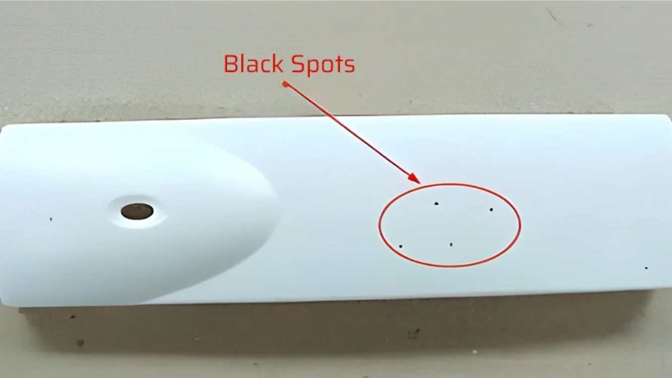 Injection molded product with visible dark spots